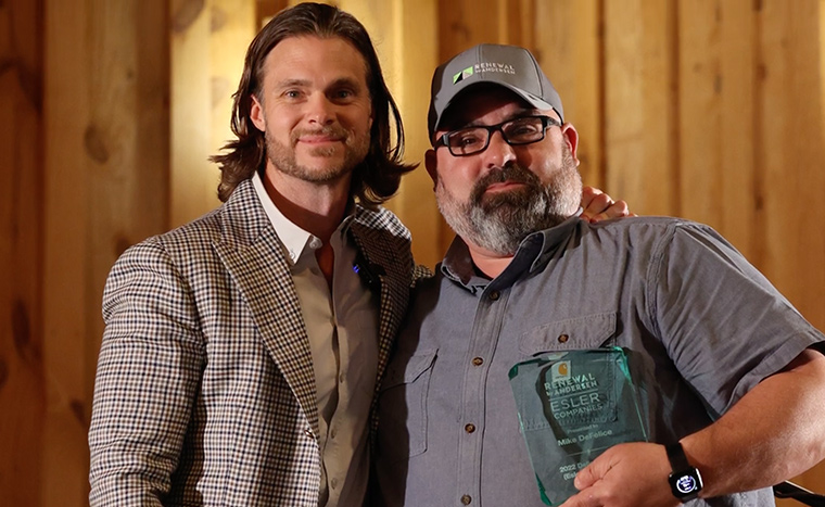 Central Texas Kickoff Highlight Image of Employee Holding Award Standing With Andrew Haskins