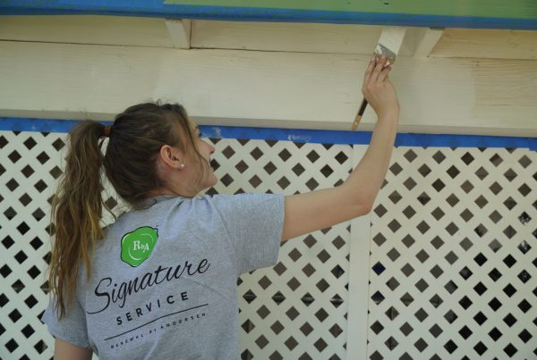 esler companies gives back with rebuilding day in las vegas - employee painting a home